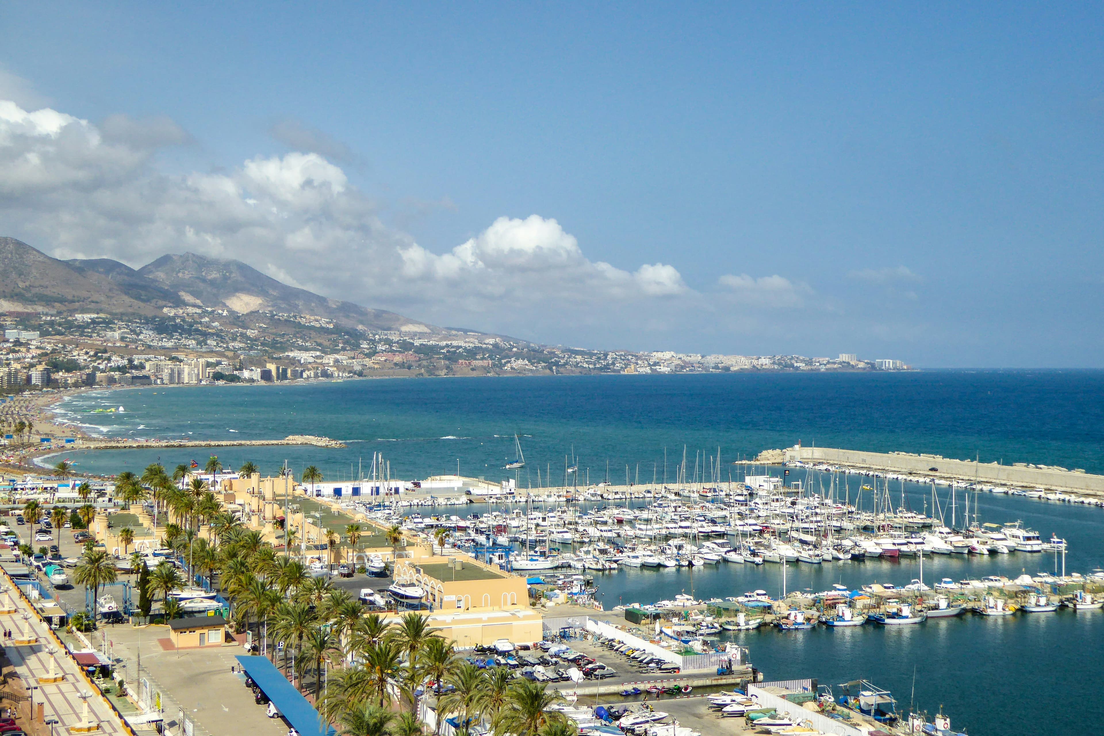 Fuengirola marina filled with boats and lined with palm trees